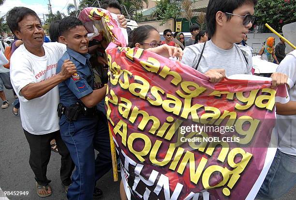 Hacienda Luisita farmers along with student activists scuffle with policemen during a rally near the house of presidential candidate and senator...