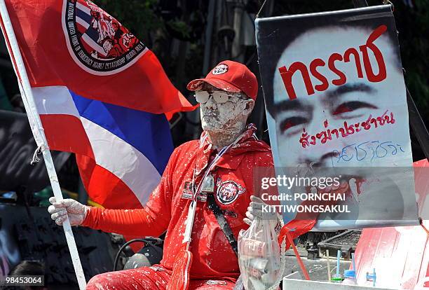 Red Shirt" anti-government protester sits on abandoned Thai army armoured vehicle at the Democracy Monument as the anti-government rally continues in...