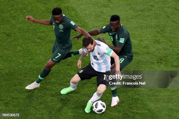 Lionel Messi of Argentina is challenged by Ahmed Musa and Oghenekaro Etebo of Nigeria during the 2018 FIFA World Cup Russia group D match between...