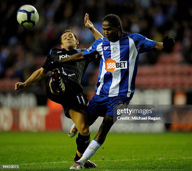 Michael Brown of Portsmouth is challenged by Hugo Rodallega of Wigan during the Barclays Premier League match between Wigan Athletic and Portsmouth...