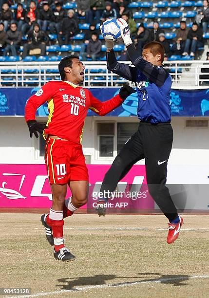 China's Changchun Yatai's Richardo Steer and Japan's Kashima Antlers' goalkeeper Sogahata Hitoshi fight for the ball during an AFC Champions League...
