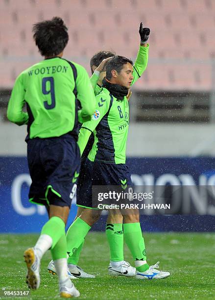 Enio Oliveira Junior of South Korea's Jeonbuk Motors celebrates his goal with teammates against Indonesia's Persipura Jayapura during a preliminary...