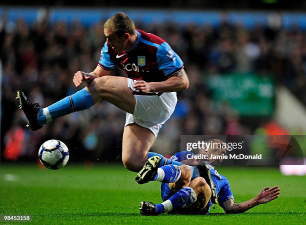 Leon Osman of Everton tangles with Richard Dunne of Aston Villa during the Barclays Premier League match between Aston Villa and Everton at Villa...