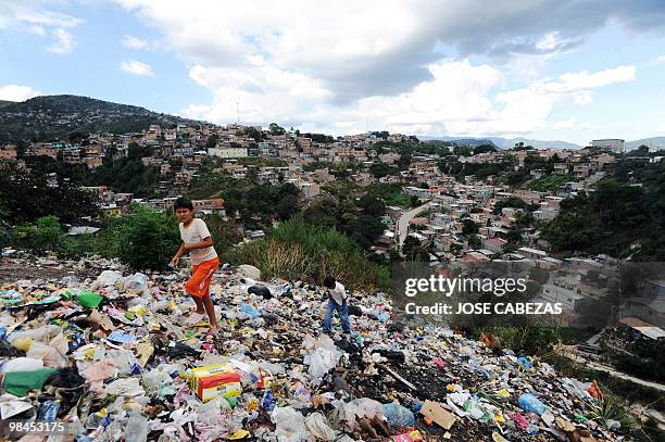 Children play in a dump at Santa Cecilia neighborhood in Comayaguela, Honduras on October 4 100 days after the coup d'etat in the country. AFP PHOTO/...