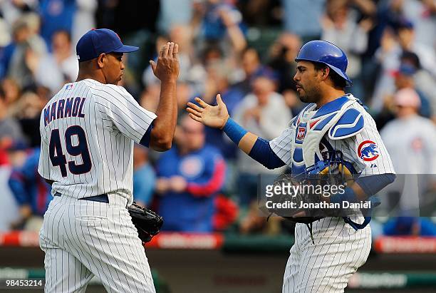 Carlos Marmol of the Chicago Cubs shakes hands with catcher Geovany Soto after a win over the Milwaukee Brewers on Opening Day at Wrigley Field on...