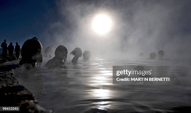 Tourists are seen bathing in hot springs near the small village of Agua Brava, more than 4000 meters above sea level, in the Uyuni salt flats,...