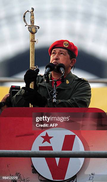 Venezuelan President Hugo Chavez draws the sword of national hero Simon Bolivar during a ceremony to commemorate the eighth anniversary of the failed...