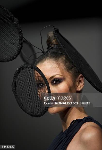 Model displays a creation by Mexican designer David Salomon during the Mercedes Benz Fashion Week in Mexico City on April 13, 2010. AFP PHOTO/Ronaldo...