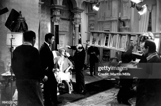 Director of photography Gianni Di Venanzo checks the lighting for the scene with American comedienne, actress, singer and businesswoman Edie Adams...