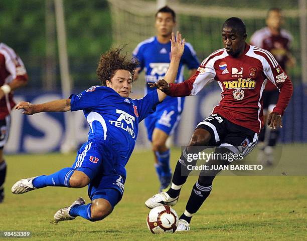 Edson Puch of Universidad de Chile, vies for the ball with Zamir Veloyes of Venezuela's Caracas FC, during their Libertadores Cup football match, at...