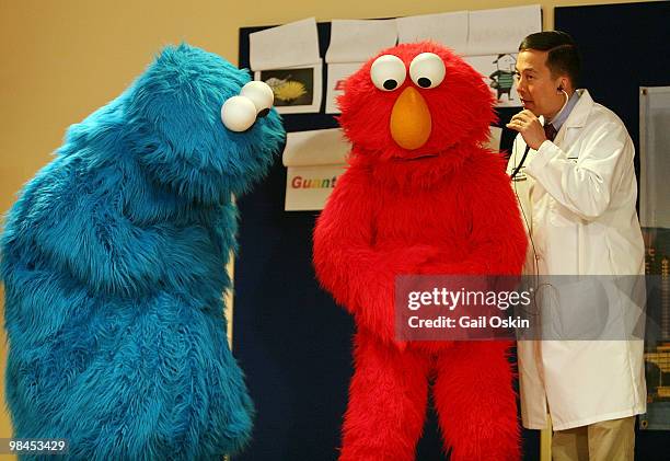 The Cookie Monster and Elmo get checked out by Dr. Vinny Chiang on the Midweek Morning Show at Children's Hospital Boston on April 14, 2010 in...