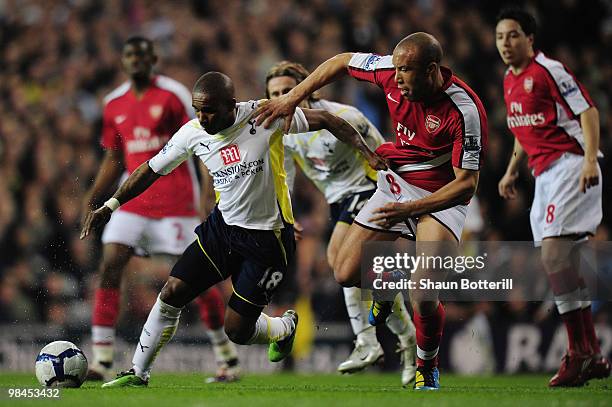 Mikael Silvestre of Arsenal challenges Jermain Defoe of Tottenham Hotspur during the Barclays Premier League match between Tottenham Hotspur and...