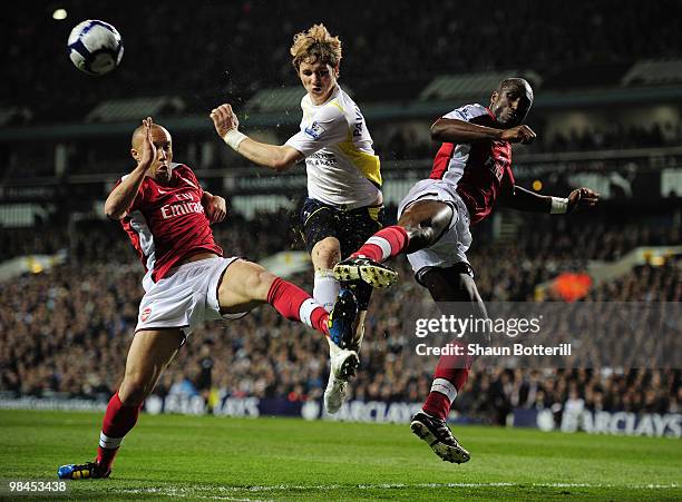 Mikael Silvestre and Sol Campbell of Arsenal challenge Roman Pavlyuchenko of Tottenham Hotspur during the Barclays Premier League match between...