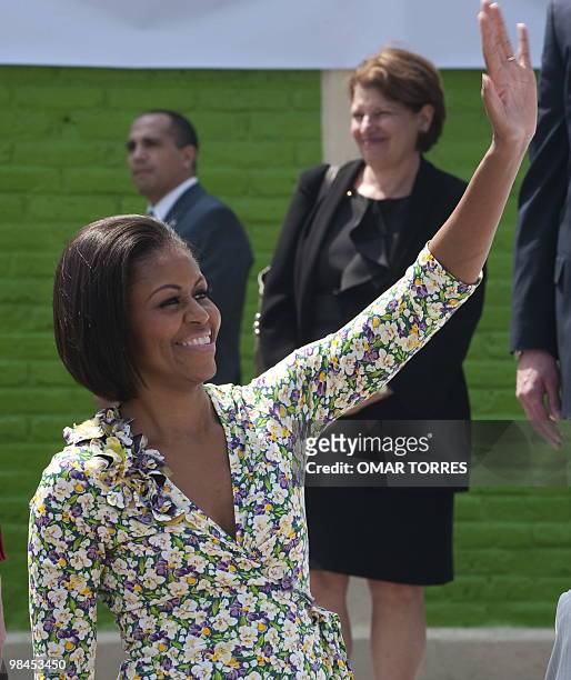 First Lady Michelle Obama waves to children during her visit to the "7 de Enero" primary public school in Mexico city on April 14, 2010. Mrs.Obama is...
