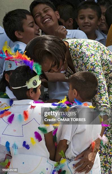 First Lady Michelle Obama greets children during her visit to the "7 de Enero" primary public school in Mexico City on April 14, 2010. Mrs.Obama is...