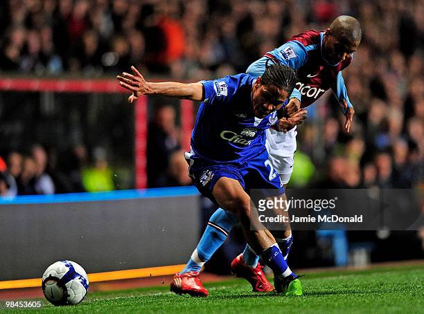 Steven Pienaar of Everton is challenged by Ashley Young of Aston Villa during the Barclays Premier League match between Aston Villa and Everton at...