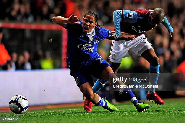 Steven Pienaar of Everton is challenged by Ashley Young of Aston Villa during the Barclays Premier League match between Aston Villa and Everton at...