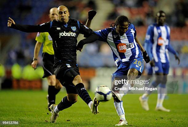 Anthony Vanden Borra of Portsmouth challenges Hugo Rodallega of Wigan during the Barclays Premier League match between Wigan Athletic and Portsmouth...
