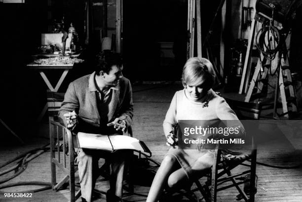 American comedienne, actress, singer and businesswoman Edie Adams talks backstage with American actor Cliff Robertson during the filming of 'The...