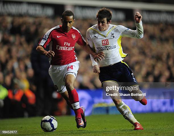 Theo Walcott of Arsenal is challenged by Gareth Bale of Tottenham Hotspur during the Barclays Premier League match between Tottenham Hotspur and...