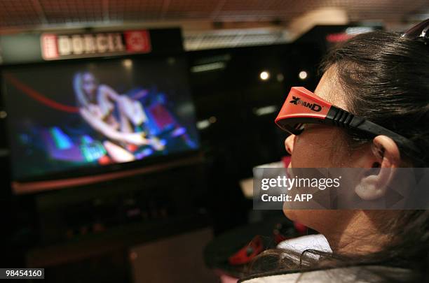 Visitor watches a 3D porn movie on April 13, 2010 in Cannes, southern France, taken during the MIPTV, one of the world's largest broadcasting and...