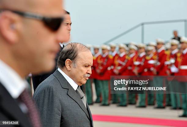 Algerian President Abdelaziz Bouteflika is seen surrounded by security upon his arrival to receive his Vietnamese counterpart Nguyen Minh Triet at...