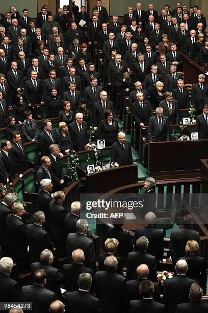 Jaroslaw Kaczynski , twin brother of late Polish President Lech Kaczynski, and other parliamentarians stand next to empty seats with pictures of...