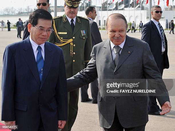 Algerian President Abdelaziz Bouteflika walks with his Vietnamese counterpart Nguyen Minh Triet during a welcoming ceremony at Houari Boumediene...