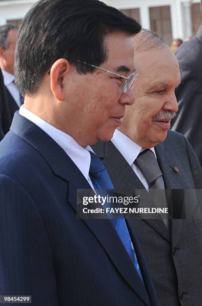 Algerian President Abdelaziz Bouteflika walks with his Vietnamese counterpart Nguyen Minh Triet during a welcoming ceremony at Houari Boumediene...