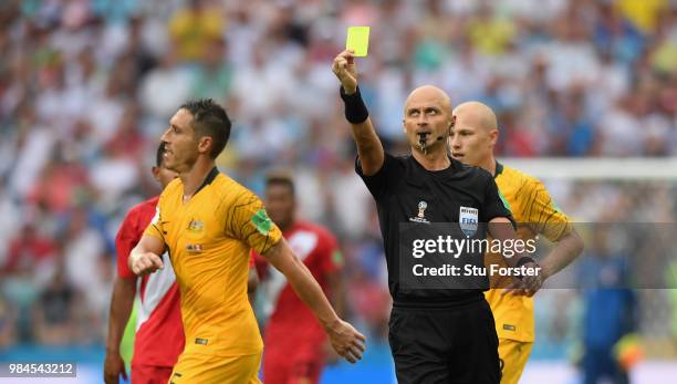 Referee Sergei Karasev issues a yellow card to Mark Milligan during the 2018 FIFA World Cup Russia group C match between Australia and Peru at Fisht...