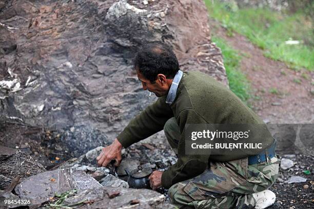Village guard prepares tea on April 10, 2010 in the mountainous southeastern city of Siirt. The village guards, made up of Kurdish peasants who fight...