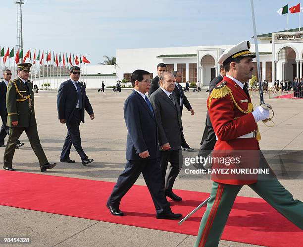 Algerian President Abdelaziz Bouteflika walks with his Vietnamese counterpart Nguyen Minh Triet during a welcoming ceremony at Houari Boumediene...