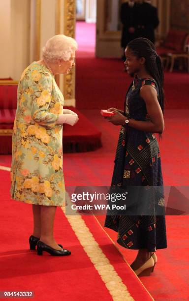 Ms Sela Kasepa from Zambia receives her Young Leaders Award from Queen Elizabeth II during the Queen's Young Leaders Awards Ceremony at Buckingham...