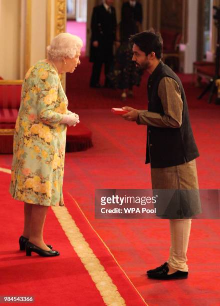 Mr. Ayman Sadiq from Bangladesh receives his Young Leaders Award from Queen Elizabeth II during the Queen's Young Leaders Awards Ceremony at...