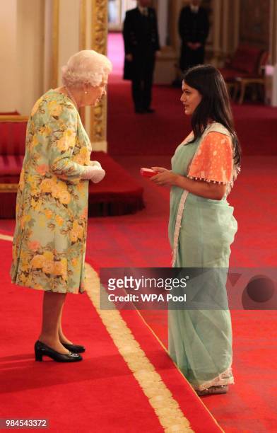 Ms Zaiba Tahyya from Bangladesh receives her Young Leaders Award from Queen Elizabeth II during the Queen's Young Leaders Awards Ceremony at...