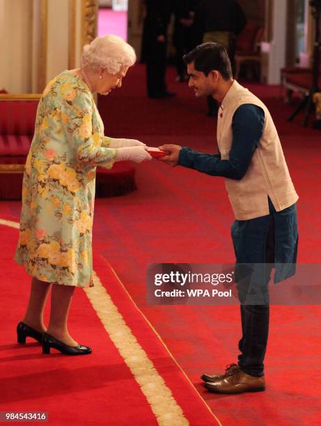 Mr. Aditya Kulkarni from India receives his Young Leaders Award from Queen Elizabeth II during the Queen's Young Leaders Awards Ceremony at...