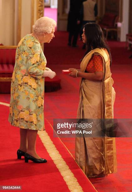 Ms Deane De Menezes from India receives her Young Leaders Award from Queen Elizabeth II during the Queen's Young Leaders Awards Ceremony at...