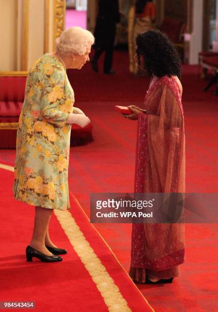 Ms Trisha Shetty from India receives her Young Leaders Award from Queen Elizabeth II during the Queen's Young Leaders Awards Ceremony at Buckingham...