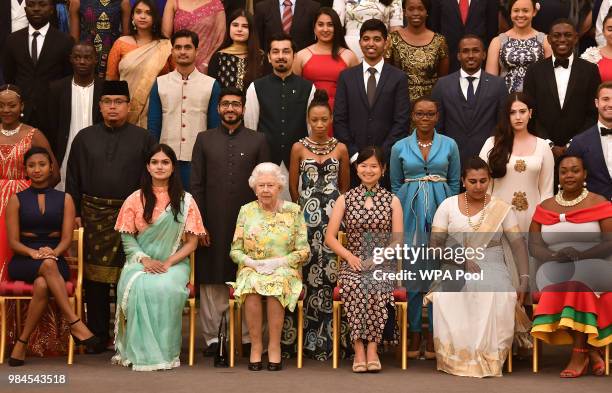 Queen Elizabeth II joins some of the Queen's Young Leaders, who received their award at the Queen's Young Leaders Awards Ceremony at Buckingham...