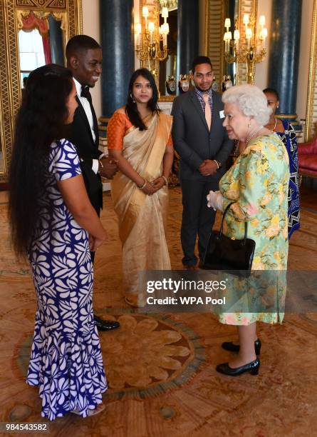 Queen Elizabeth II meets a group of Queen's Young Leaders at the Queen's Young Leaders Awards Ceremony at Buckingham Palace on June 26, 2018 in...