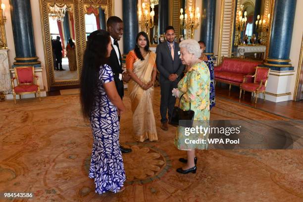 Queen Elizabeth II meets a group of Queen's Young Leaders at the Queen's Young Leaders Awards Ceremony at Buckingham Palace on June 26, 2018 in...