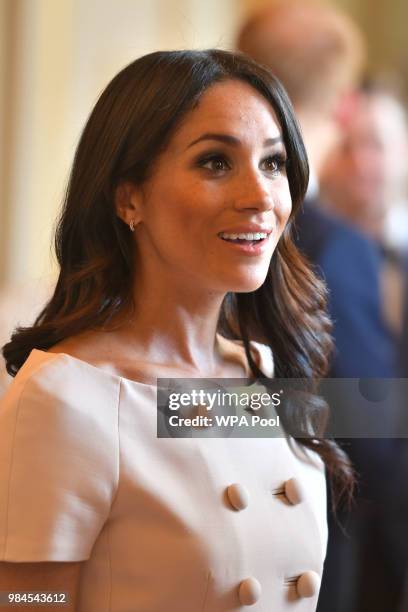 Meghan, Duchess of Sussex meets guests at the Queen's Young Leaders Awards Ceremony at Buckingham Palace on June 26, 2018 in London, England. The...