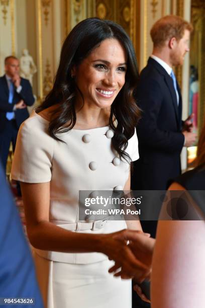 Meghan, Duchess of Sussex meets guests at the Queen's Young Leaders Awards Ceremony at Buckingham Palace on June 26, 2018 in London, England. The...