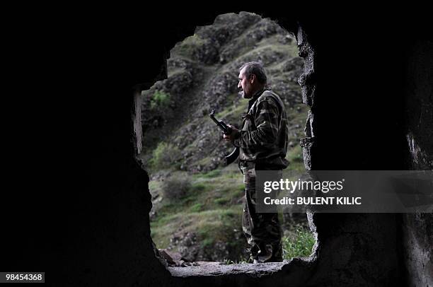 Village guard stands at the entrance of his cabin April 10, 2010 in the mountainous southeastern city of Siirt. The village guards, made up of...
