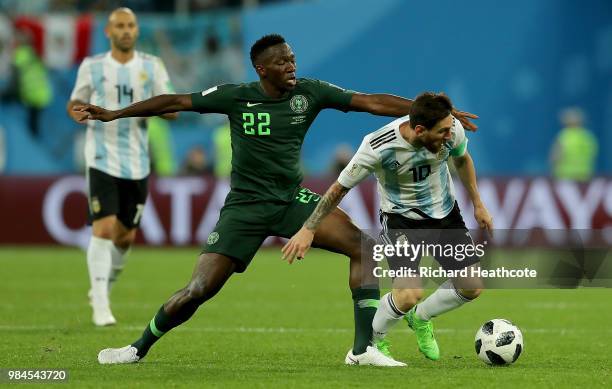 Kenneth Omeruo of Nigeria tackles Lionel Messi of Argentina during the 2018 FIFA World Cup Russia group D match between Nigeria and Argentina at...