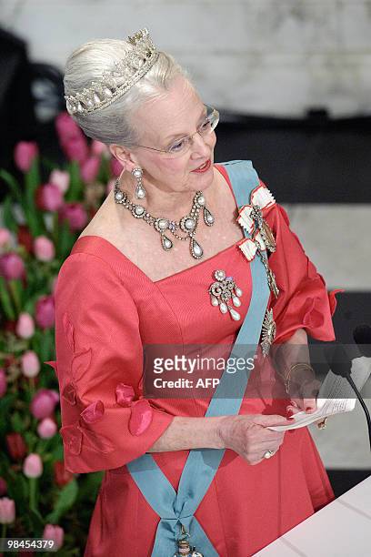 Danish Queen Margrethe raises delivers a speech at Christiansborg Palace in central Copenhagen on April 13, 2010 during the official dinner party in...