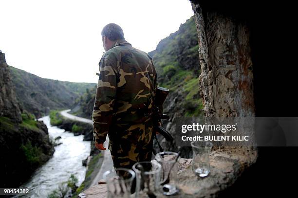 Village guard looks over the road on April 10 in the mountainous southeastern city of Siirt. The village guards, made up of Kurdish peasants who...