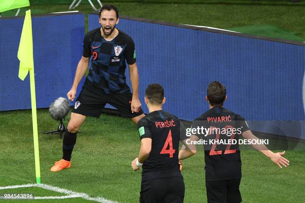 Croatia's midfielder Milan Badelj celebrates with teammates after scoring a goal during the Russia 2018 World Cup Group D football match between...