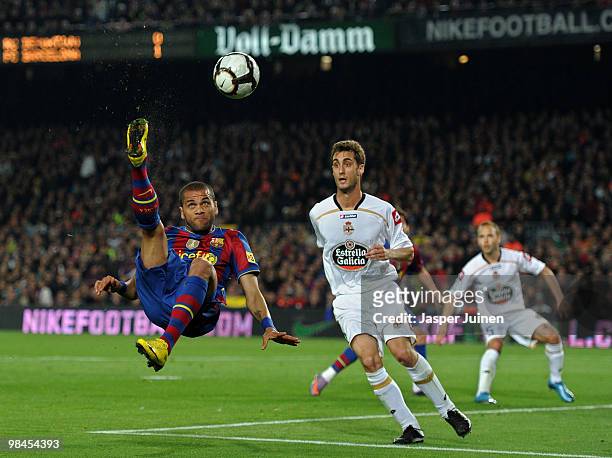 Daniel Alves of FC Barcelona tries to score past Adrian Lopez of Deportivo la Coruna during the La Liga match between Barcelona and Deportivo La...