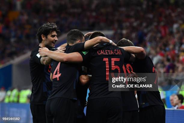 Croatia's midfielder Milan Badelj is congratulated by teammates after scoring the opening goal during the Russia 2018 World Cup Group D football...